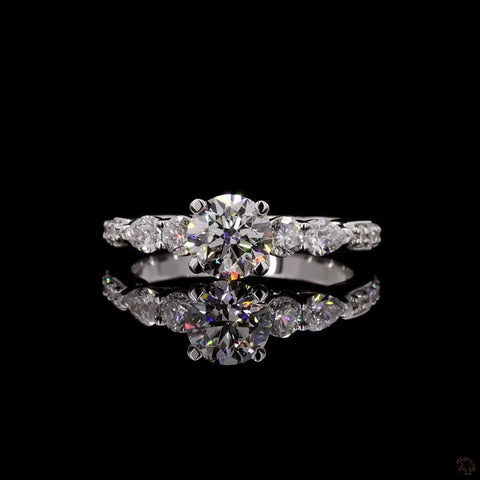 Dazzling Unity: Solitaire Engagement Ring with Side Pear Diamond.