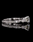 Dazzling Unity: Solitaire Engagement Ring with Side Pear Diamond.