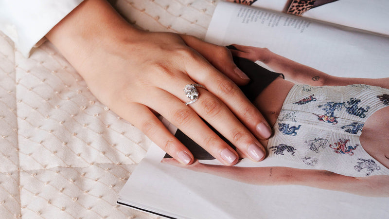 Elegant diamond engagement ring displayed on a woman’s hand